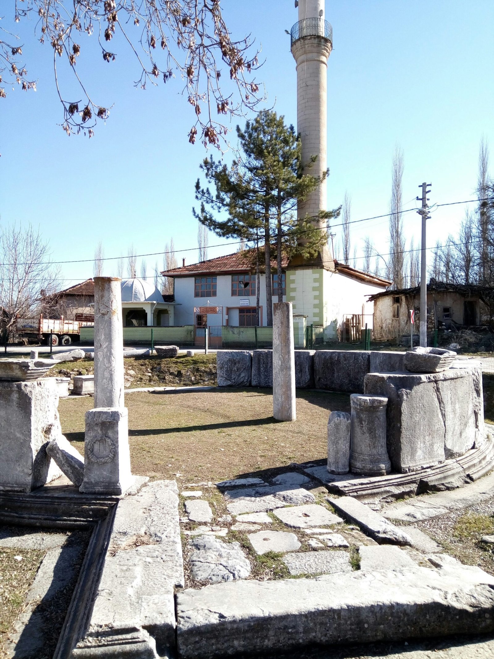 white and brown concrete building near green trees during daytime